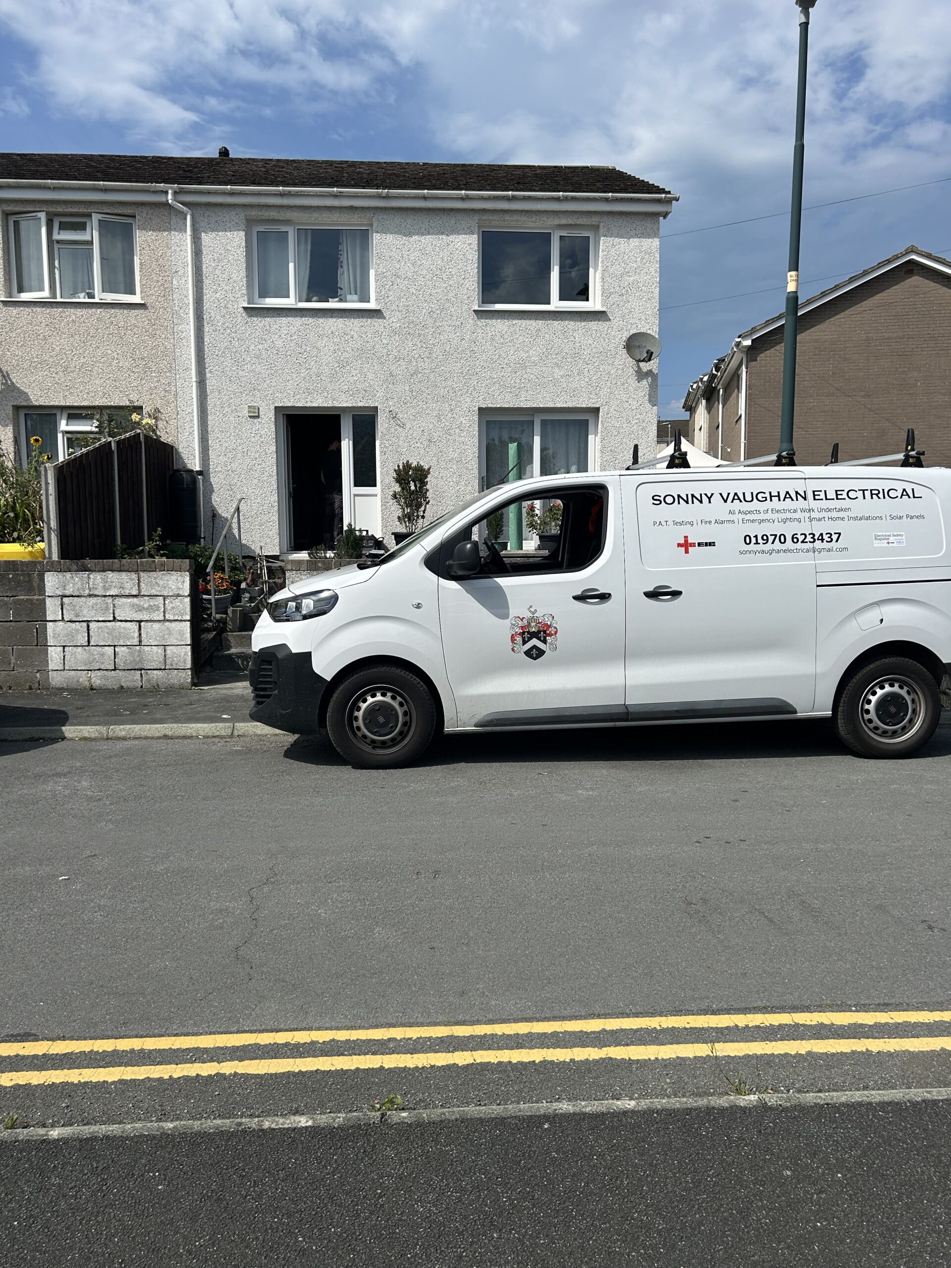 Sonny Vaughan Electrical van outside residential housing estate.