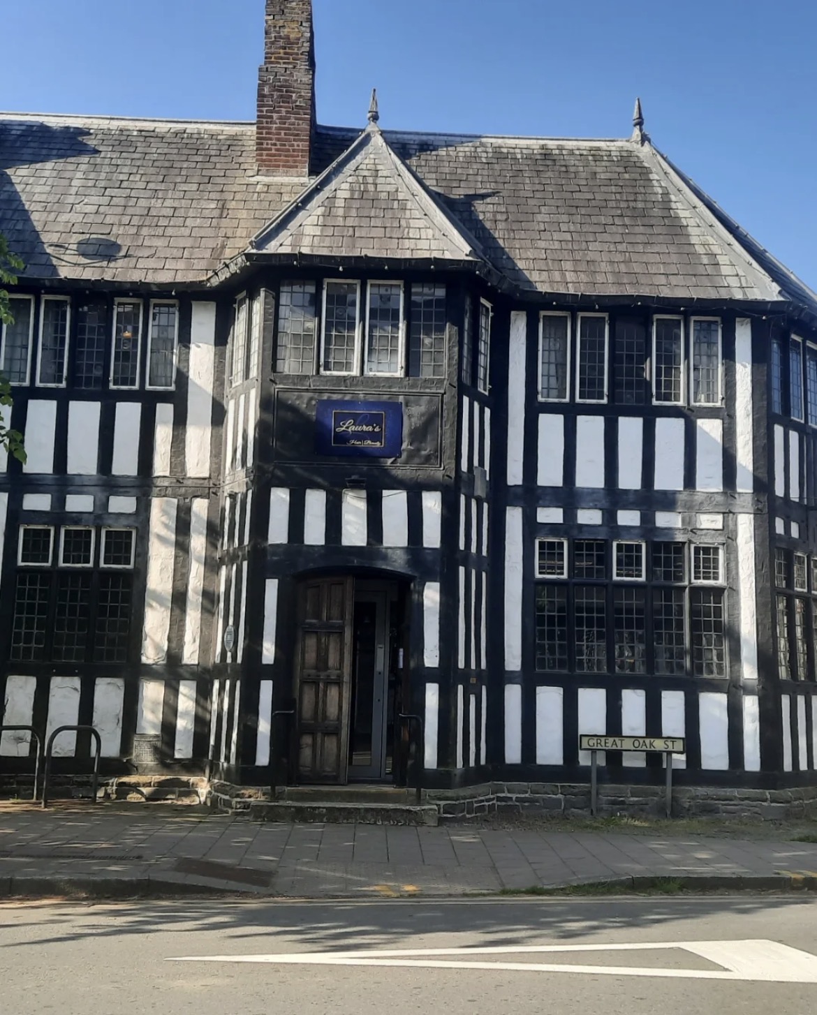 Old Victorian black and white building that has been converted into a hairdressers.